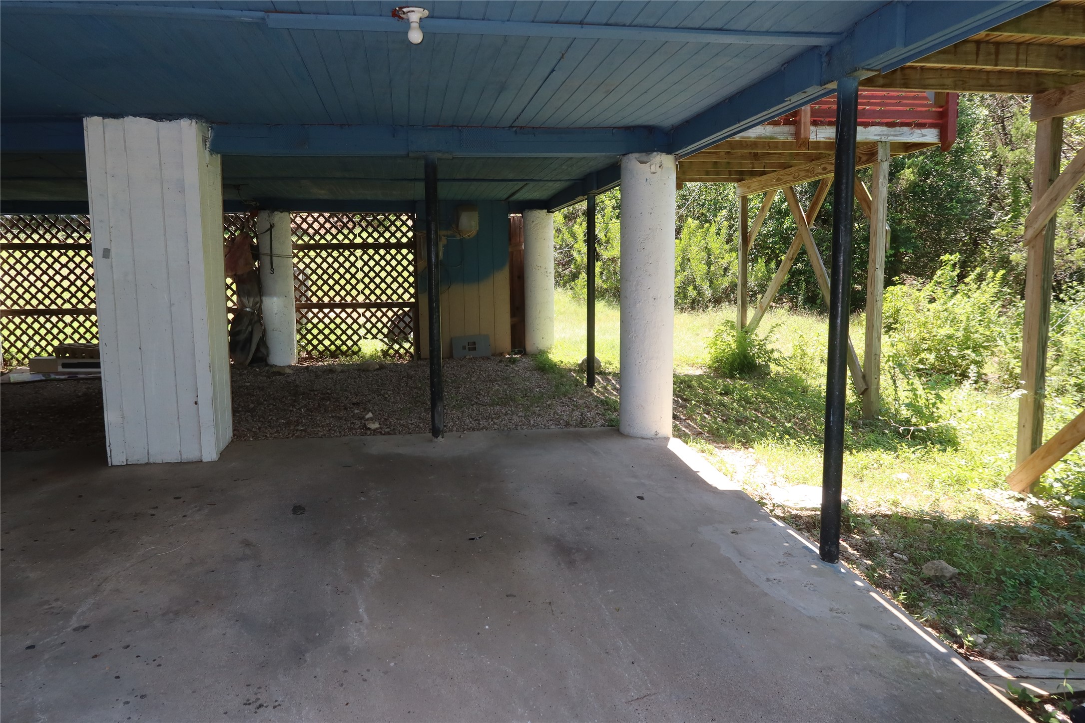 6914 Rifle Bend, Unit A Austin, TX 78736 - Photo 24 of 25 Concrete pillars support a sheltered carport and storage area underneath the elevated structure.