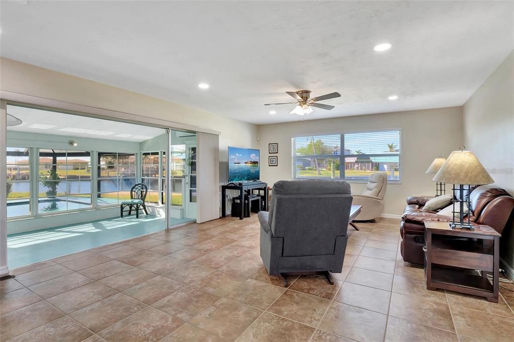 250 Bangsberg Road Southeast Port Charlotte, FL 33952 - Photo 10 of 59 a living room with furniture and a large window