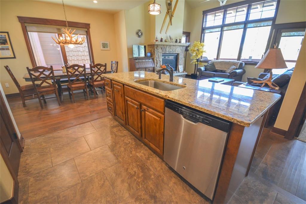 833 Independence Road, Unit 6A Keystone, CO 80435 - Photo 12 of 35 a kitchen with stainless steel appliances granite countertop a stove a sink and a microwave