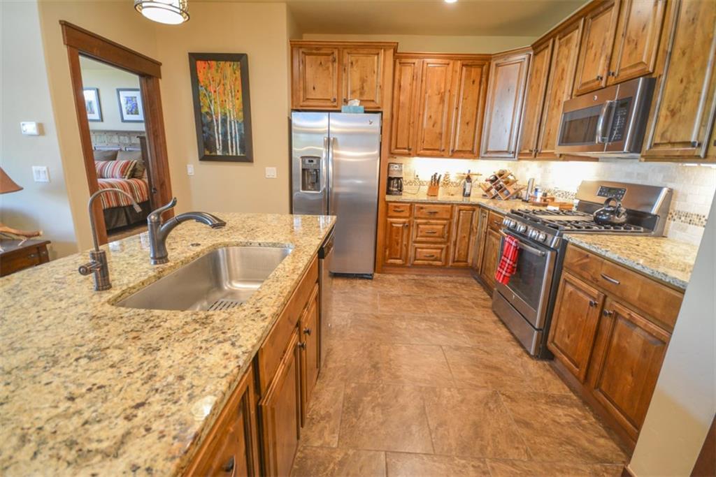 833 Independence Road, Unit 6A Keystone, CO 80435 - Photo 13 of 35 a kitchen with stainless steel appliances granite countertop a sink stove and refrigerator