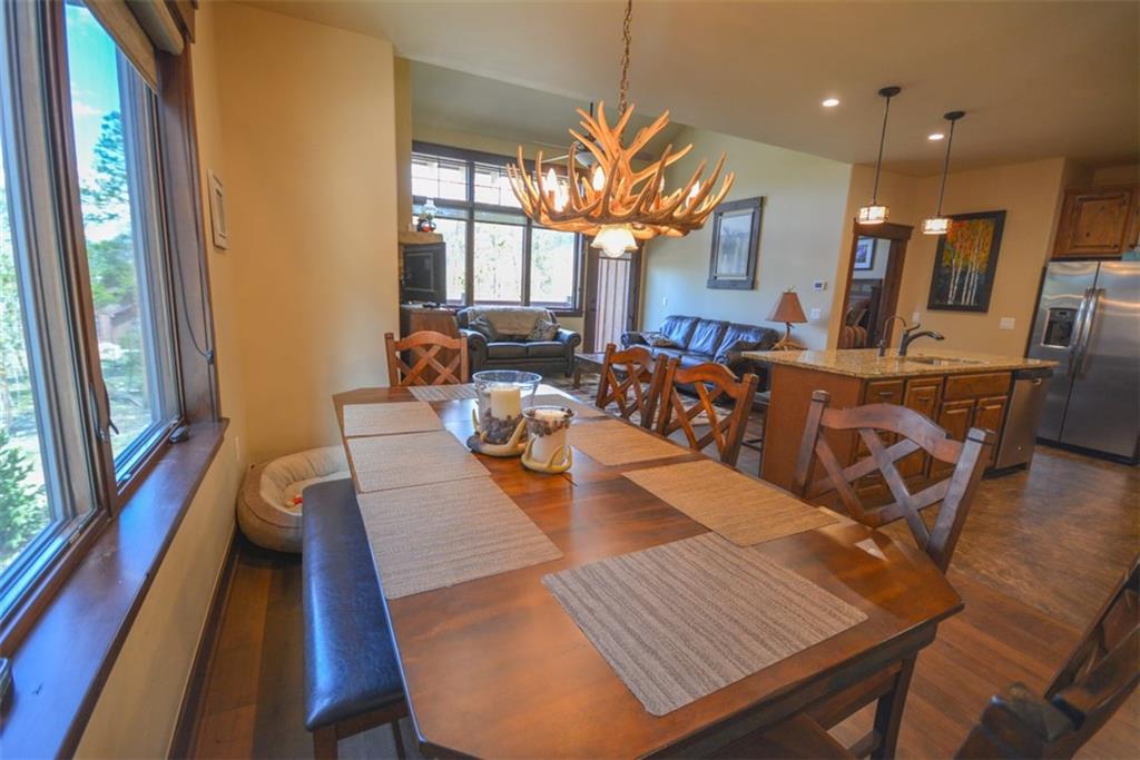 833 Independence Road, Unit 6A Keystone, CO 80435 - Photo 14 of 35 a view of a dining room with furniture a chandelier and wooden floor