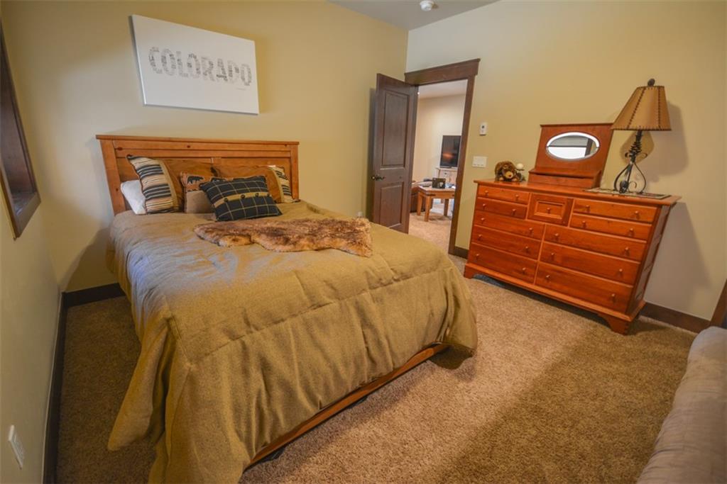 833 Independence Road, Unit 6A Keystone, CO 80435 - Photo 20 of 35 a bedroom with a bed and wooden floor