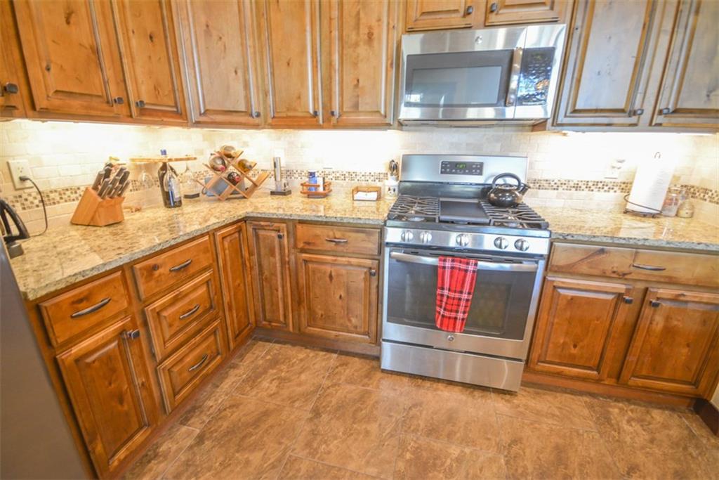 833 Independence Road, Unit 6A Keystone, CO 80435 - Photo 25 of 35 a kitchen with stainless steel appliances granite countertop a sink stove and cabinets