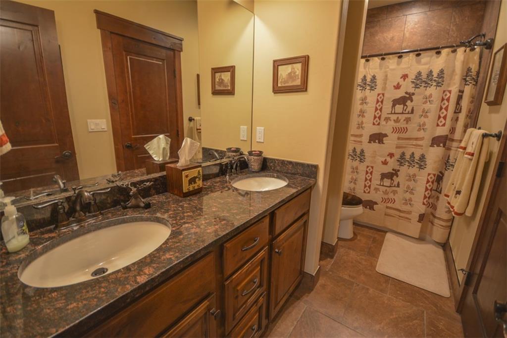 833 Independence Road, Unit 6A Keystone, CO 80435 - Photo 34 of 35 a bathroom with a granite countertop sink toilet and shower