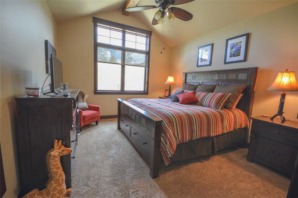 833 Independence Road, Unit 6A Keystone, CO 80435 - Photo 6 of 35 a bedroom with a bed and a chandelier
