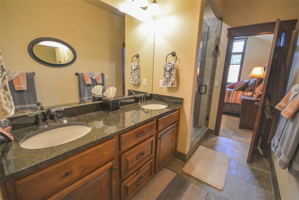 833 Independence Road, Unit 6A Keystone, CO 80435 - Photo 7 of 35 a bathroom with a granite countertop sink and a mirror