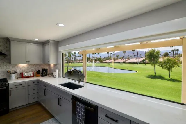 a kitchen with a sink and a large window