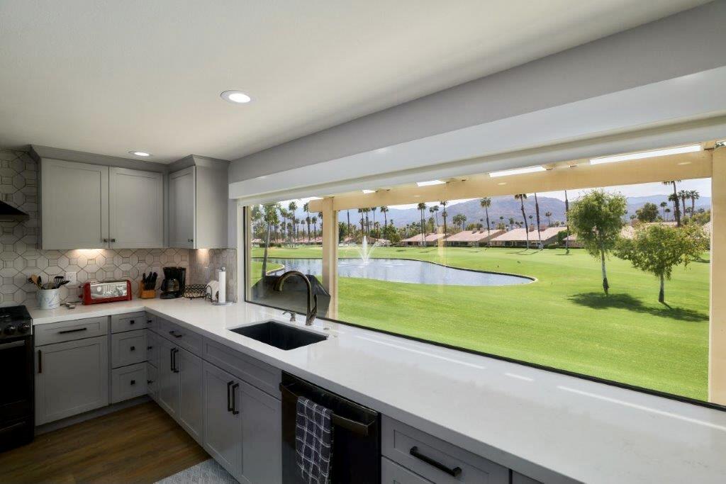 a kitchen with a sink and a large window