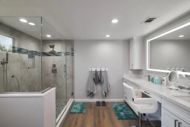 a bathroom with a sink a toilet and shower