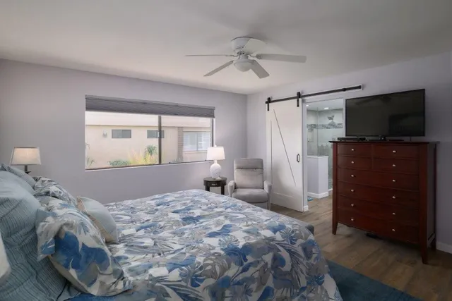 a bedroom with a bed and a flat screen tv