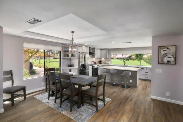 a view of a dining room with furniture window and wooden floor