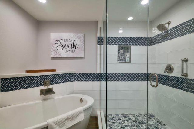 a bathroom with a bathtub and shower