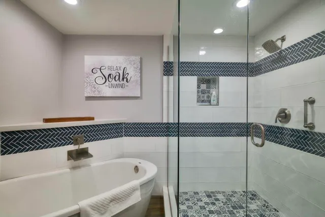 a bathroom with a bathtub and shower