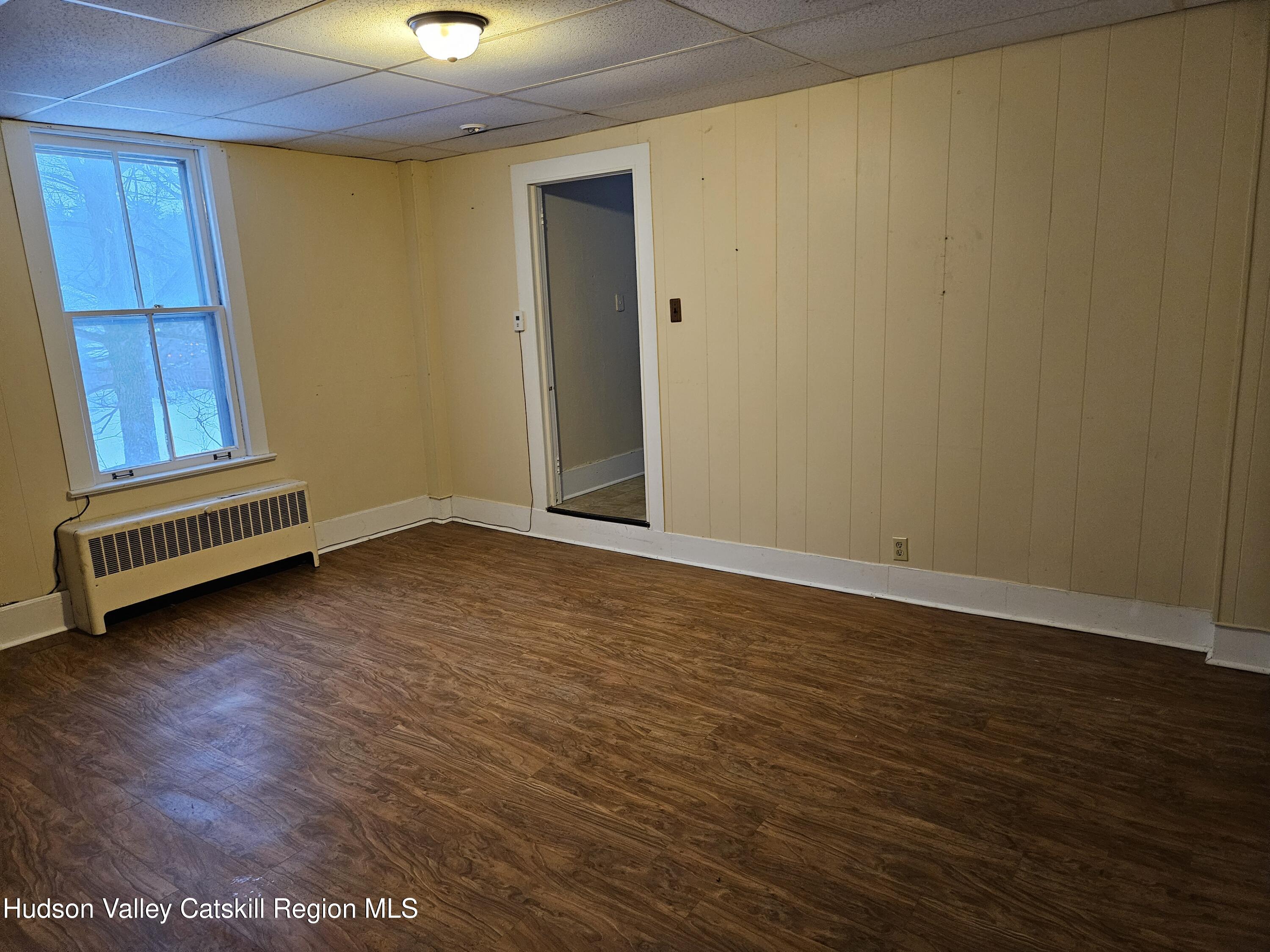 3630 County Rt 67 Freehold, NY 12431 - Photo 3 of 7 an empty room with wooden floor and windows