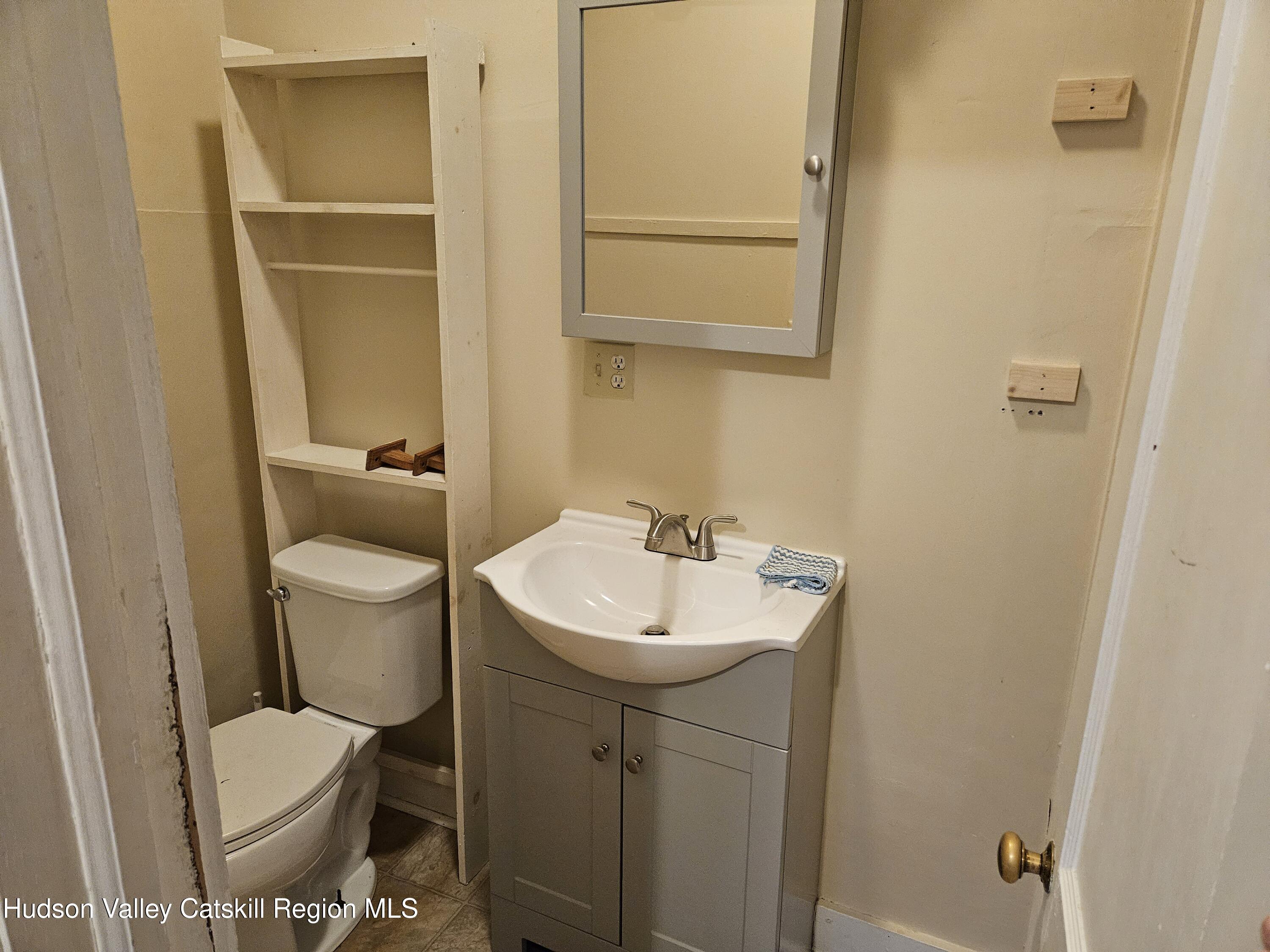 3630 County Rt 67 Freehold, NY 12431 - Photo 7 of 7 a bathroom with a toilet sink and mirror