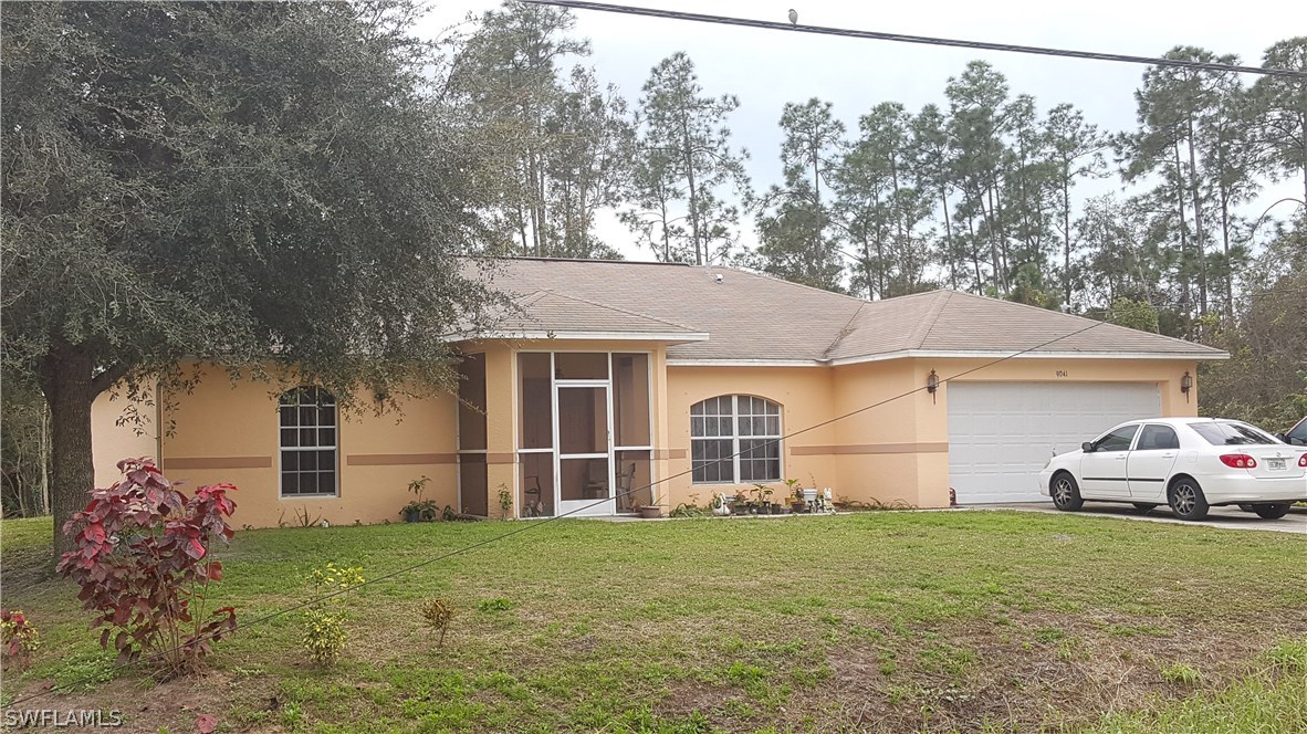 9041 Buckingham Road Fort Myers, FL 33905 - Photo 1 of 11 front view of a house with a yard