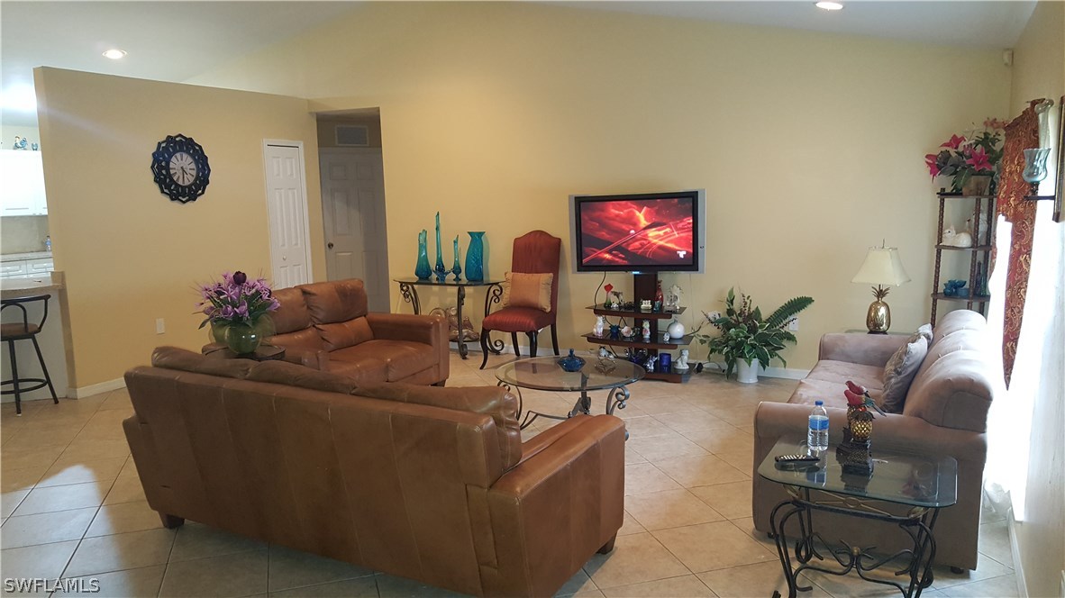 9041 Buckingham Road Fort Myers, FL 33905 - Photo 2 of 11 a living room with furniture and a flat screen tv