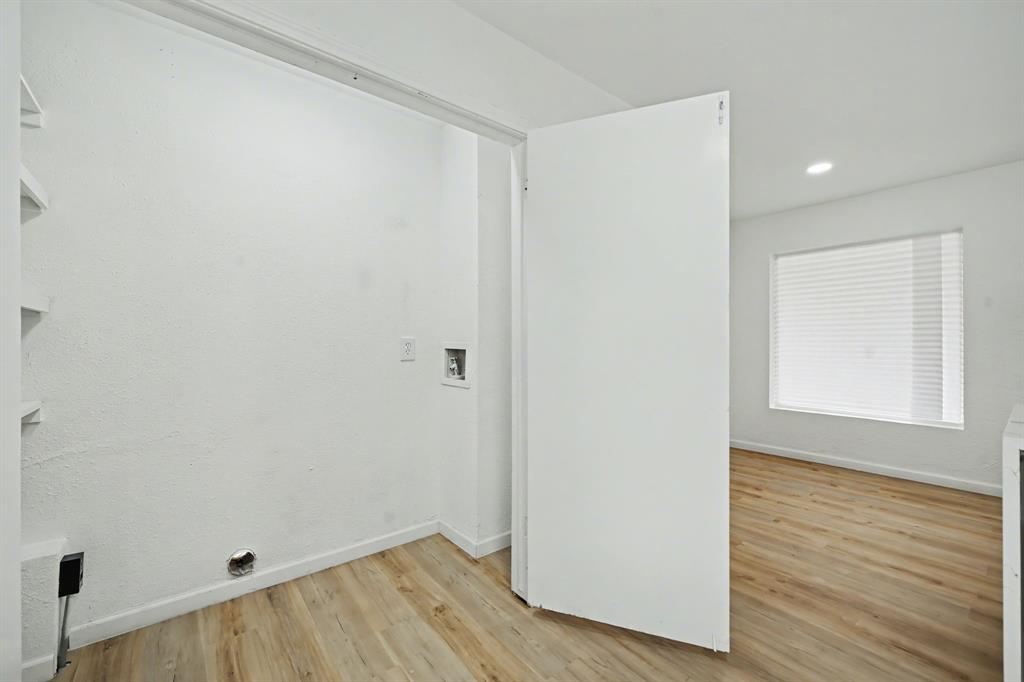 11446 Lippitt Avenue Dallas, TX 75218 - Photo 15 of 26 an empty room with wooden floor and windows
