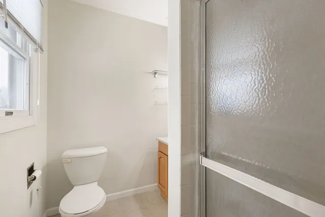 a bathroom with a toilet and a shower