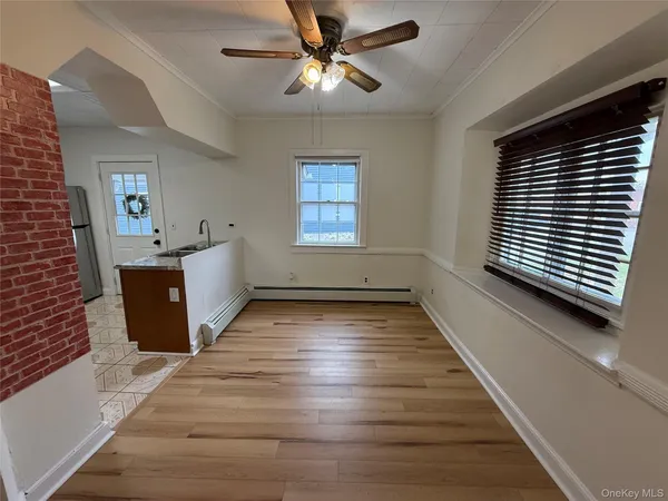 a view of a room with window and wooden floor