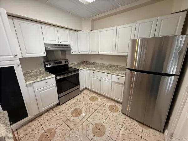 a kitchen with white cabinets sink and stainless steel appliances