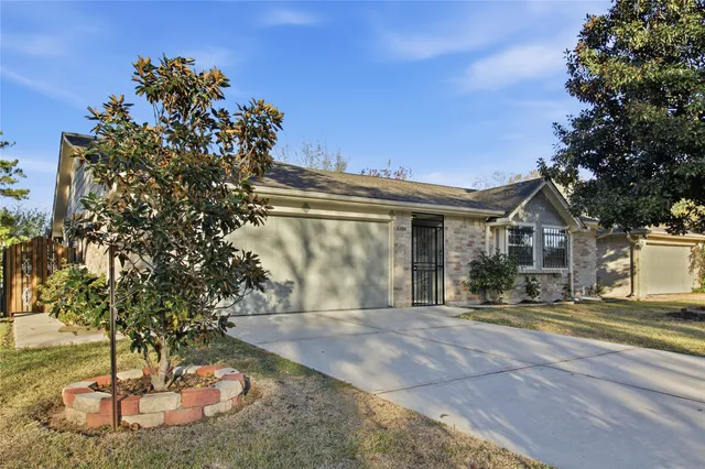 a view of a house with a tree in a yard