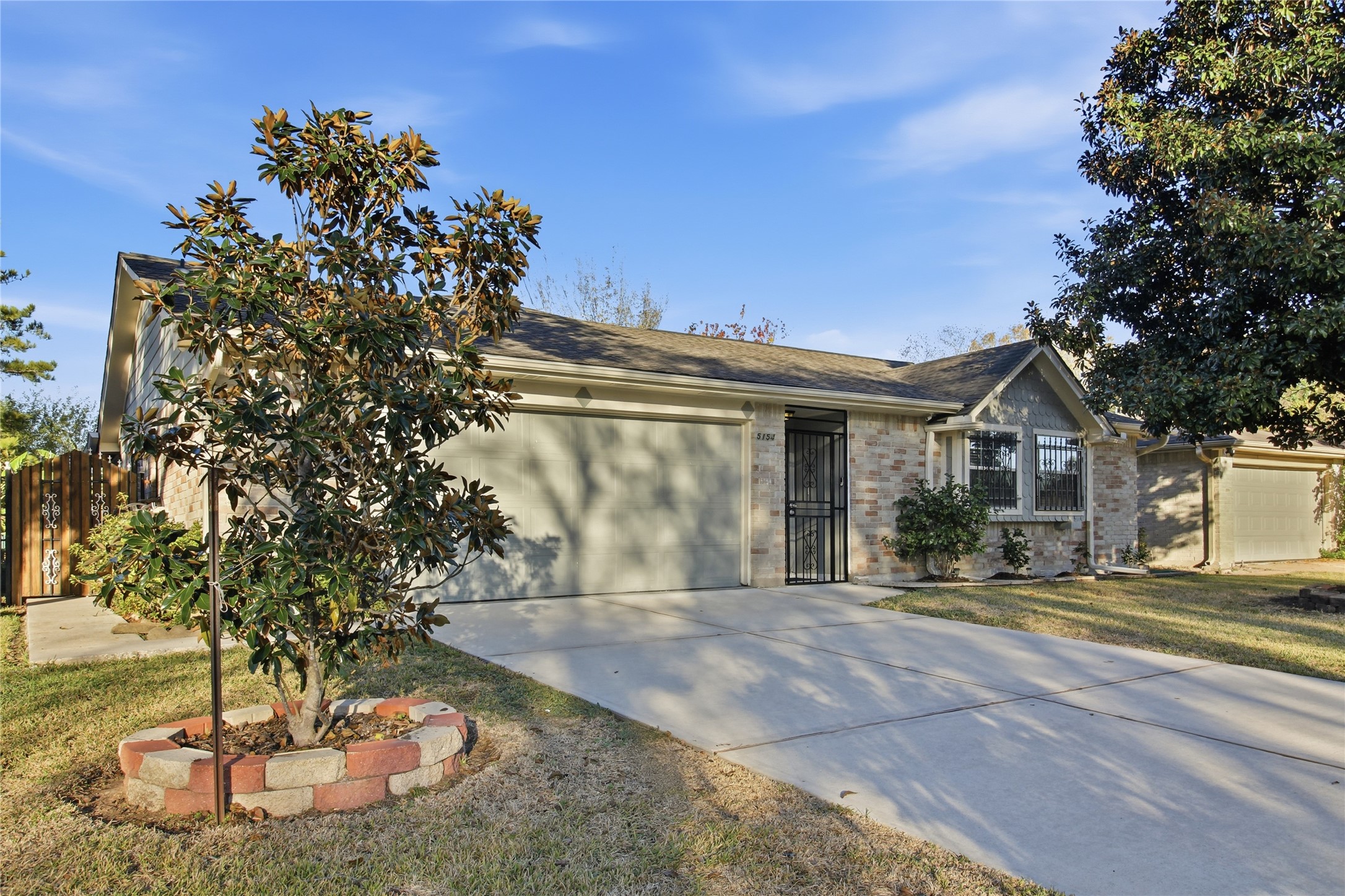 a view of a house with a tree in a yard