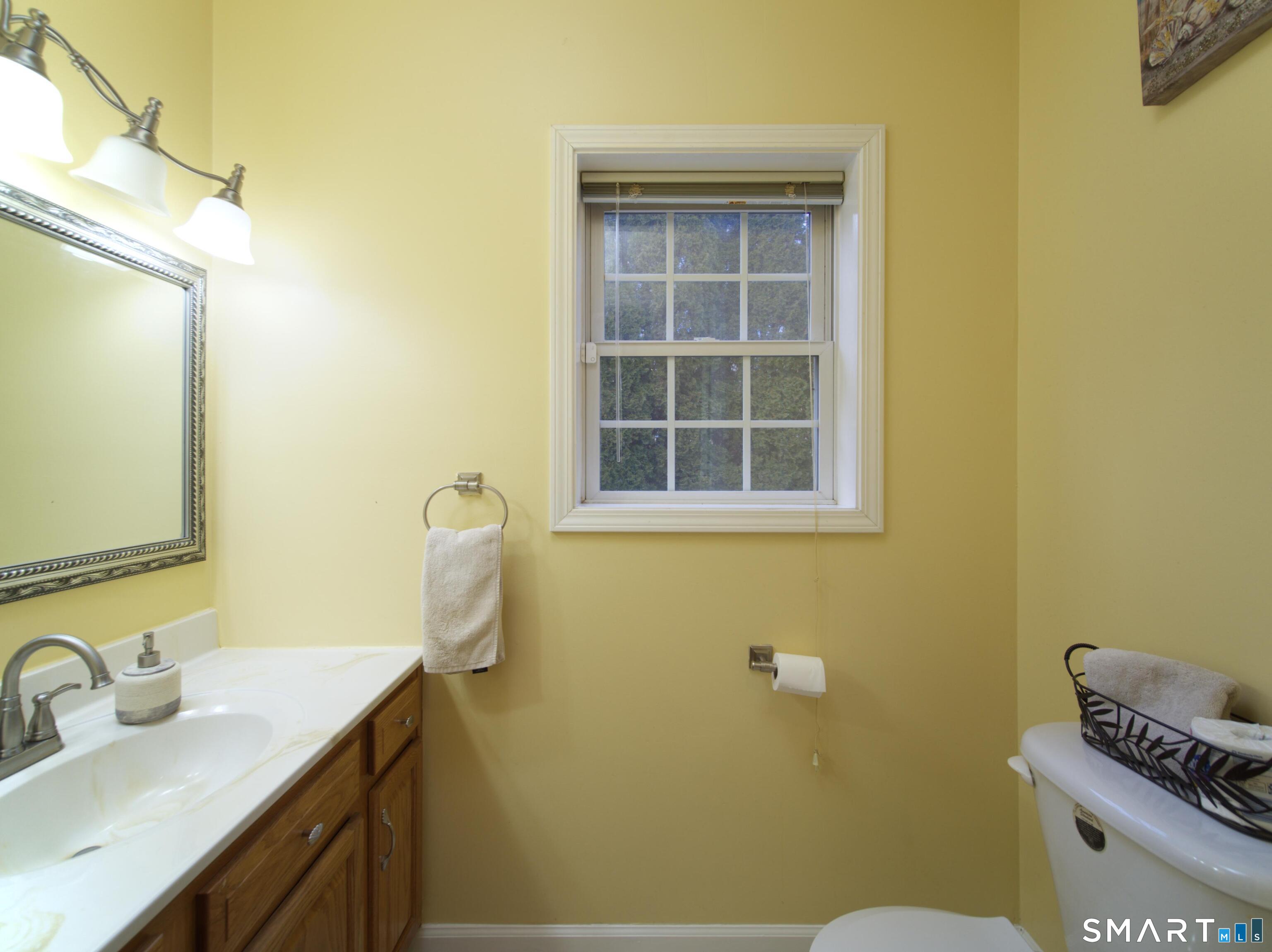 65 Benton Street, Unit 65 Fairfield, CT 06825 - Photo 11 of 35 a bathroom with a sink and a mirror