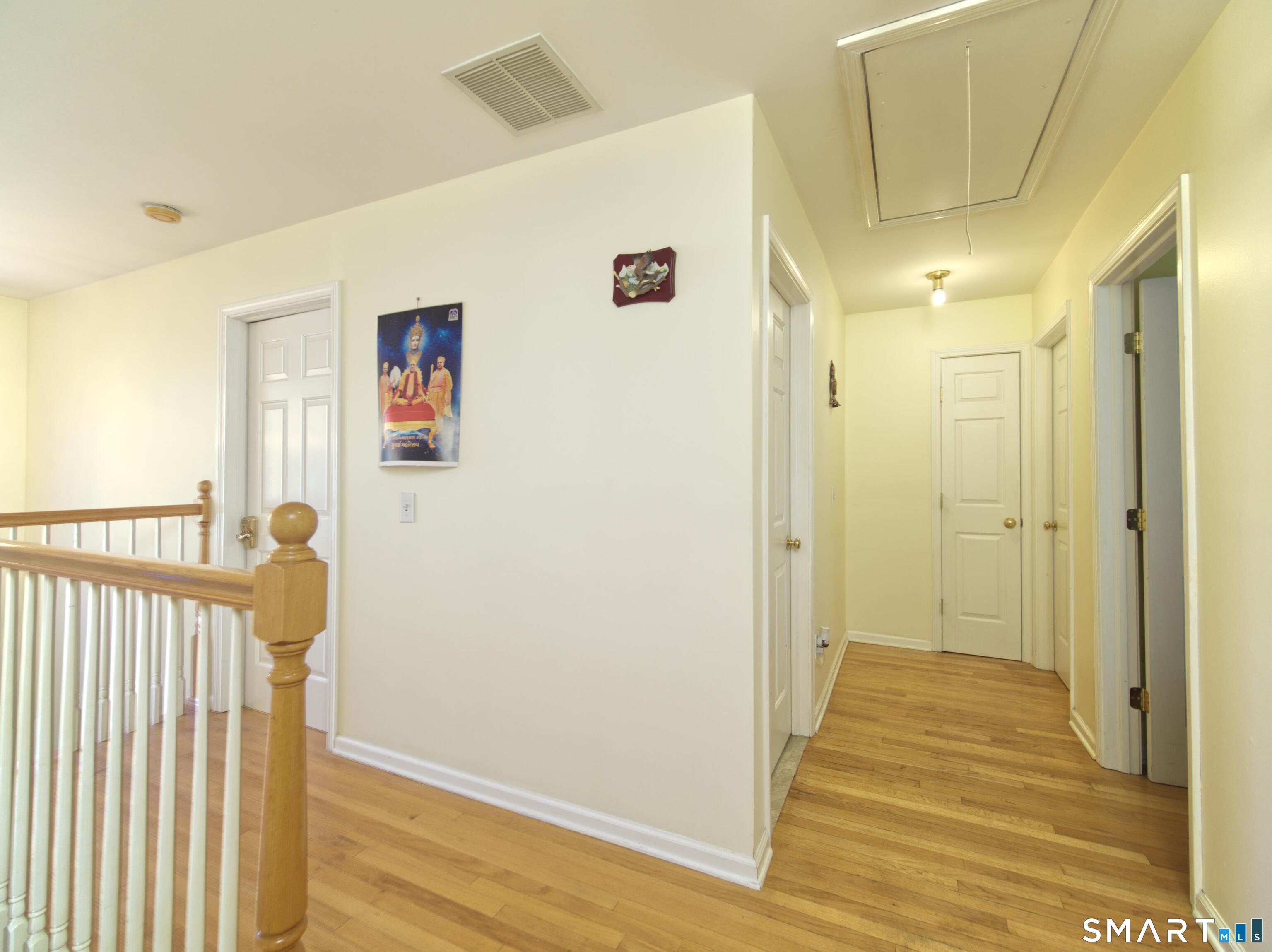 65 Benton Street, Unit 65 Fairfield, CT 06825 - Photo 13 of 35 a view of a hallway with wooden floor