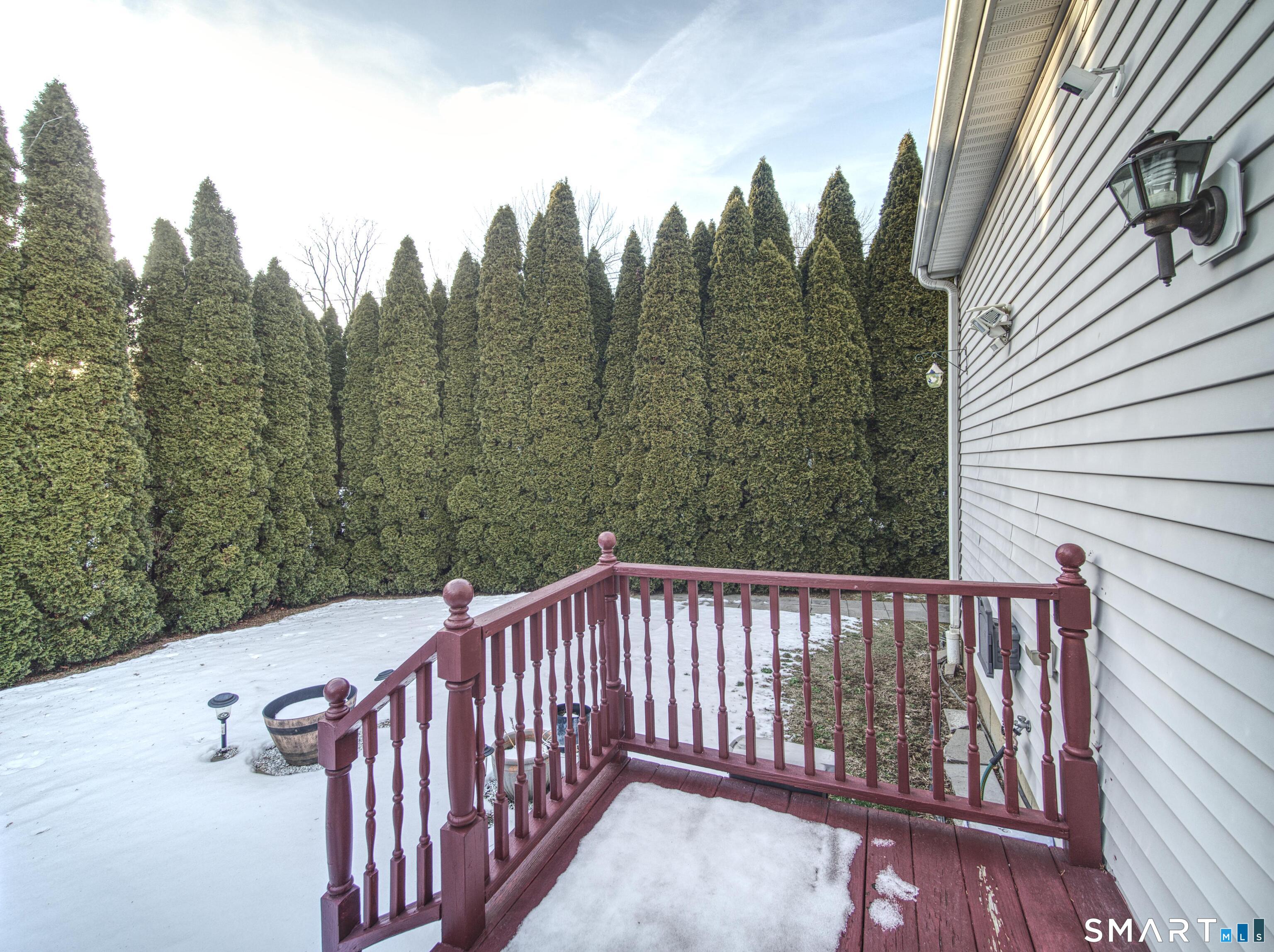 65 Benton Street, Unit 65 Fairfield, CT 06825 - Photo 21 of 35 a view of a balcony with trees