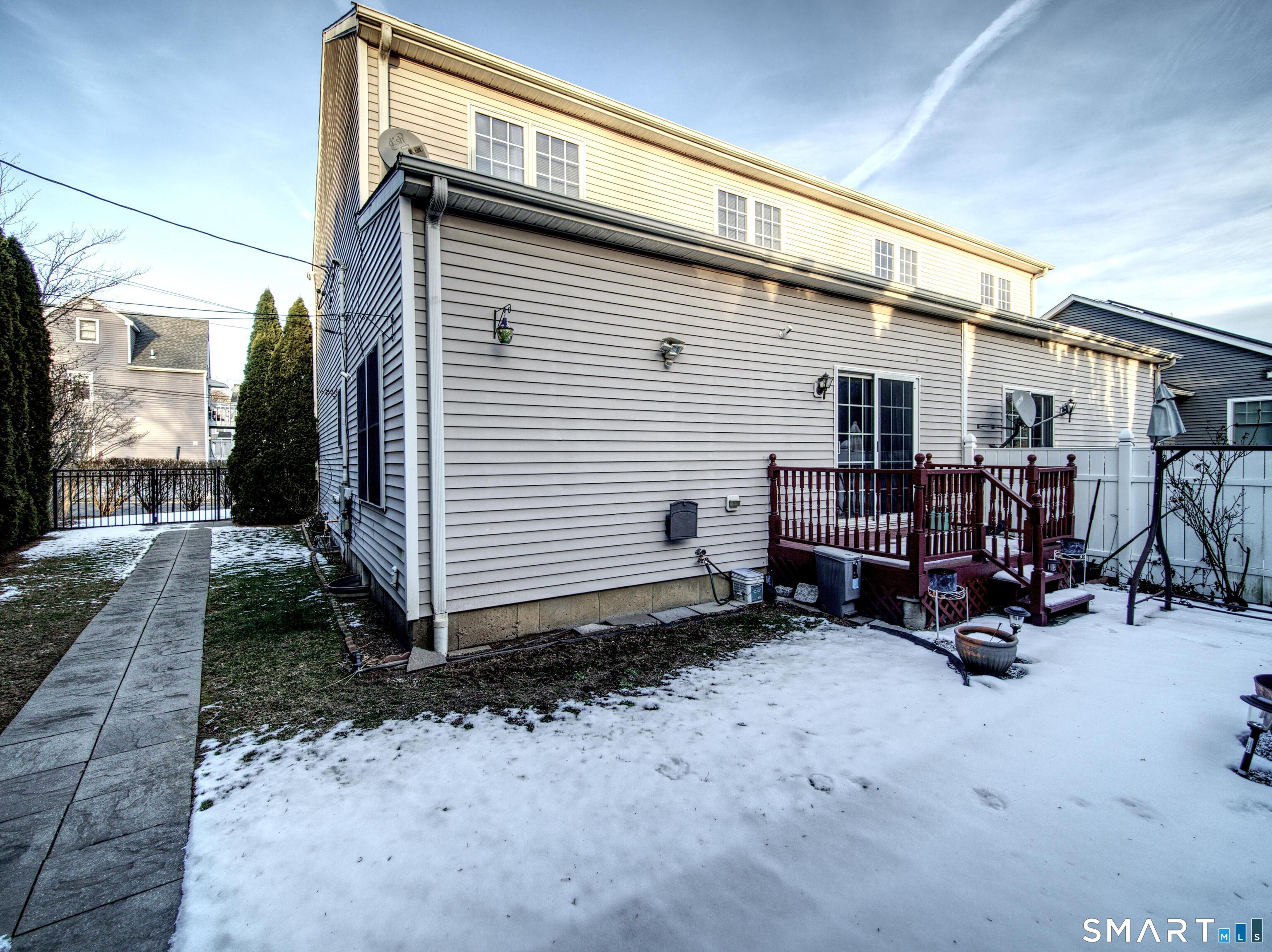 65 Benton Street, Unit 65 Fairfield, CT 06825 - Photo 25 of 35 a view of a house with a patio