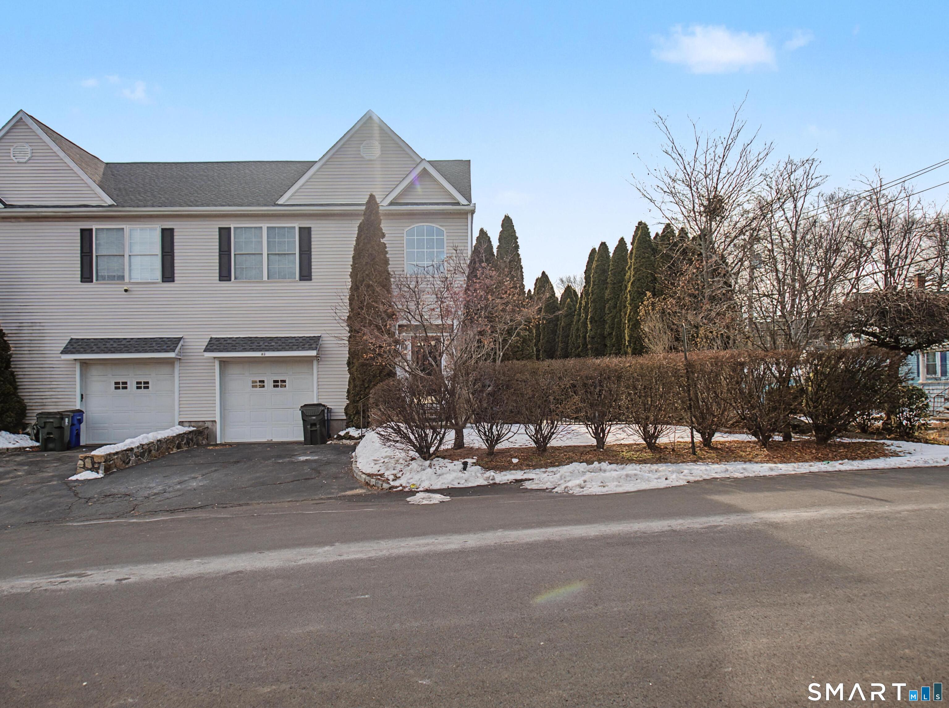 65 Benton Street, Unit 65 Fairfield, CT 06825 - Photo 26 of 35 a view of a house with a yard