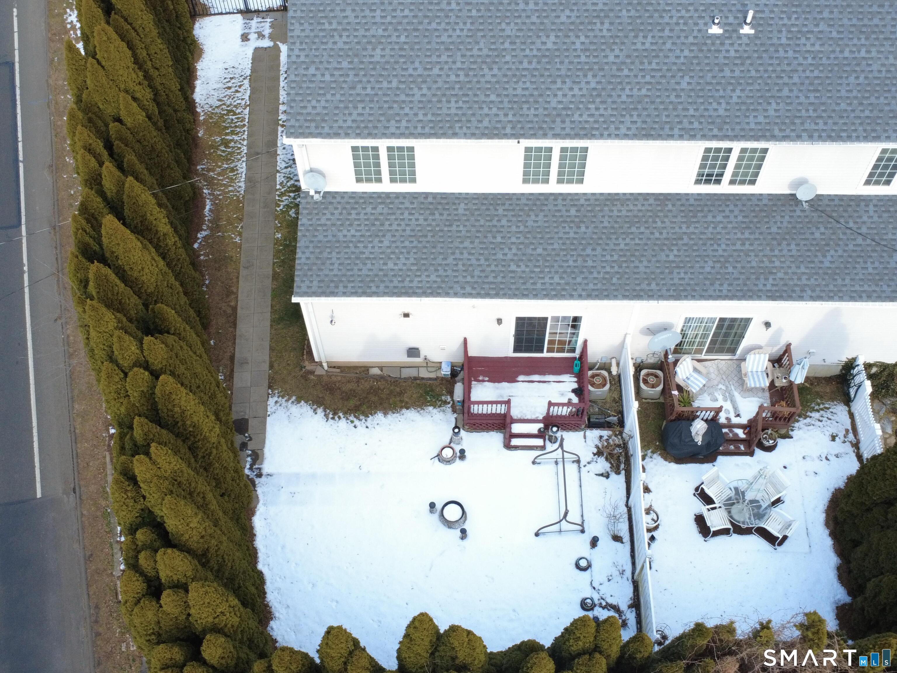 65 Benton Street, Unit 65 Fairfield, CT 06825 - Photo 34 of 35 a view of roof deck with dining table and chairs