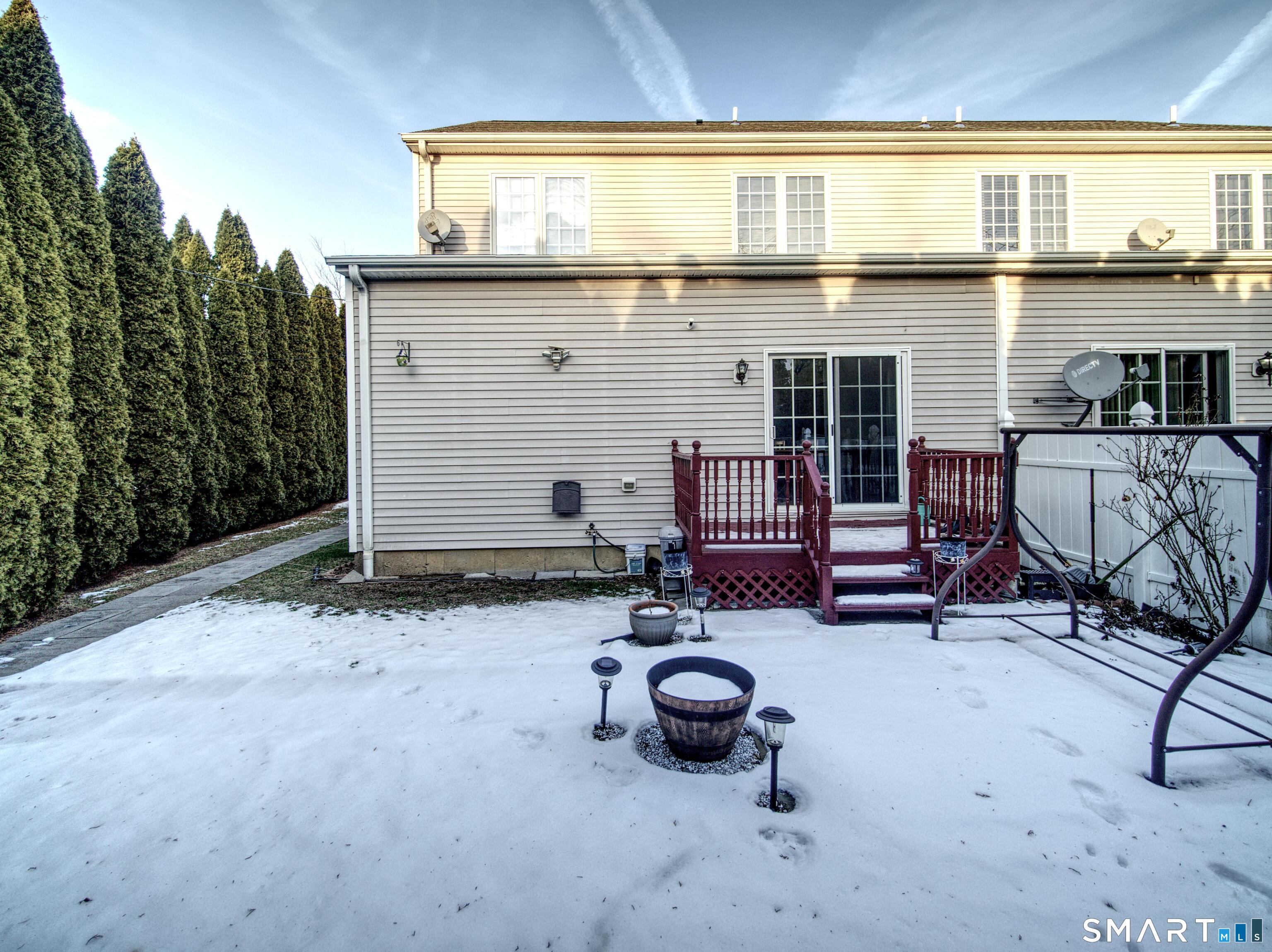 65 Benton Street, Unit 65 Fairfield, CT 06825 - Photo 35 of 35 a view of backyard with barbeque grill and wooden fence