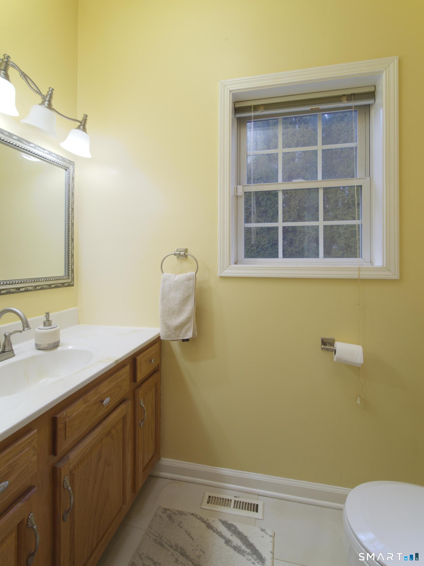 65 Benton Street, Unit 65 Fairfield, CT 06825 - Photo 10 of 35 a bathroom with a sink and a mirror
