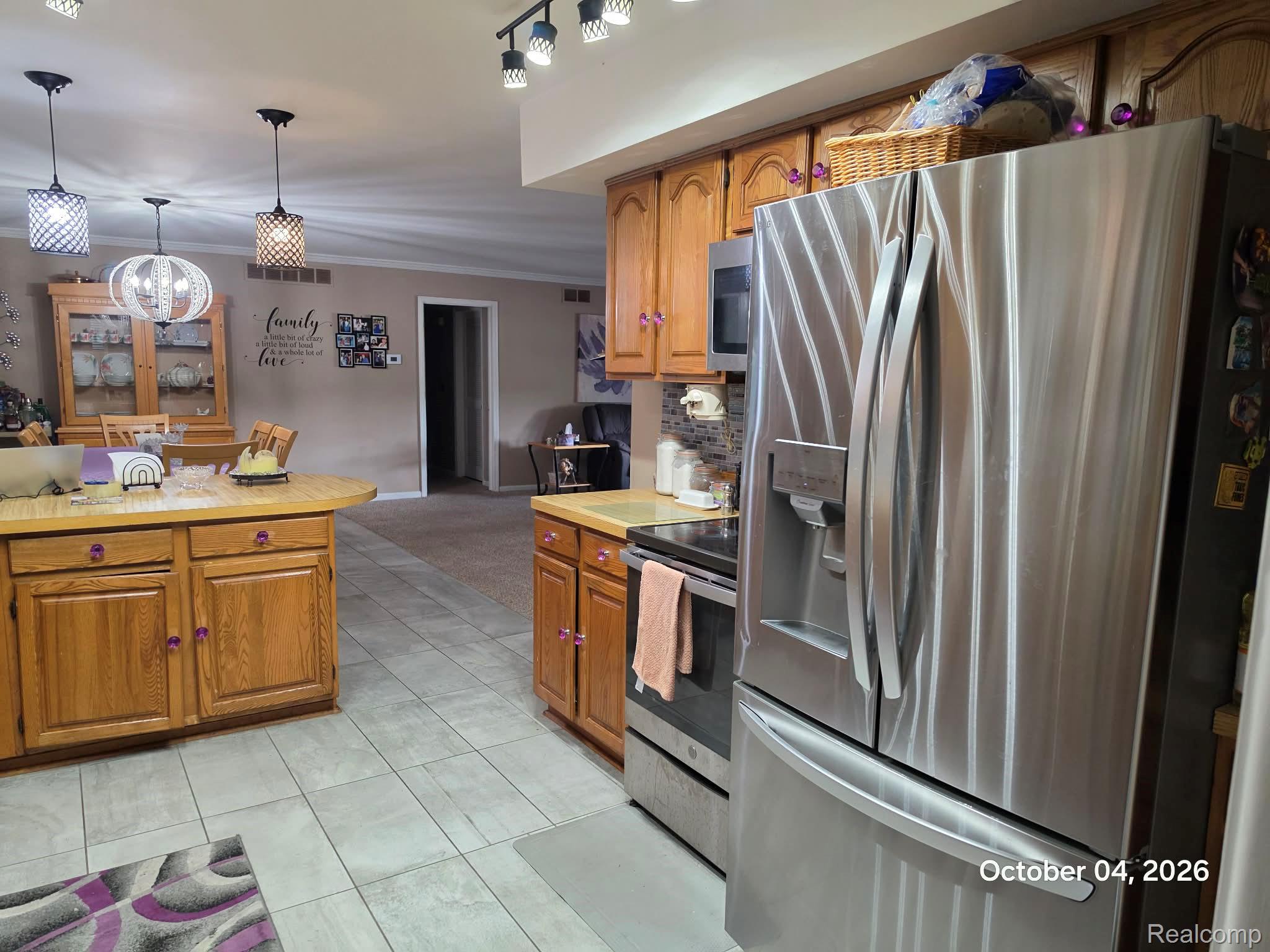 34781 Union Lake Road Clinton Township, MI 48035 - Photo 8 of 38 Kitchen featuring light wood cabinetry, a stainless steel refrigerator, and tile flooring