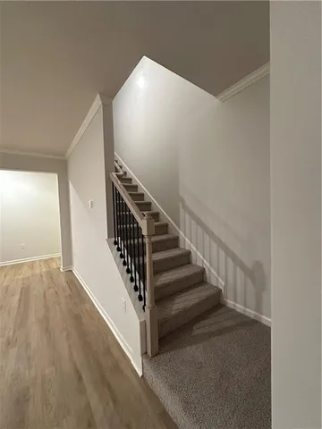 a view of entryway and hall with wooden floor