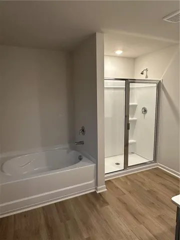 a bathroom with a bathtub and a shower
