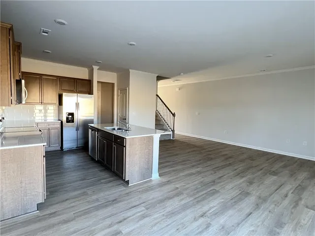 a view of kitchen with cabinets and wooden floor