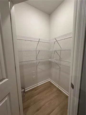 a view of a room with wooden floor