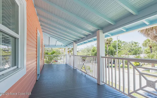 a view of a porch with wooden floor