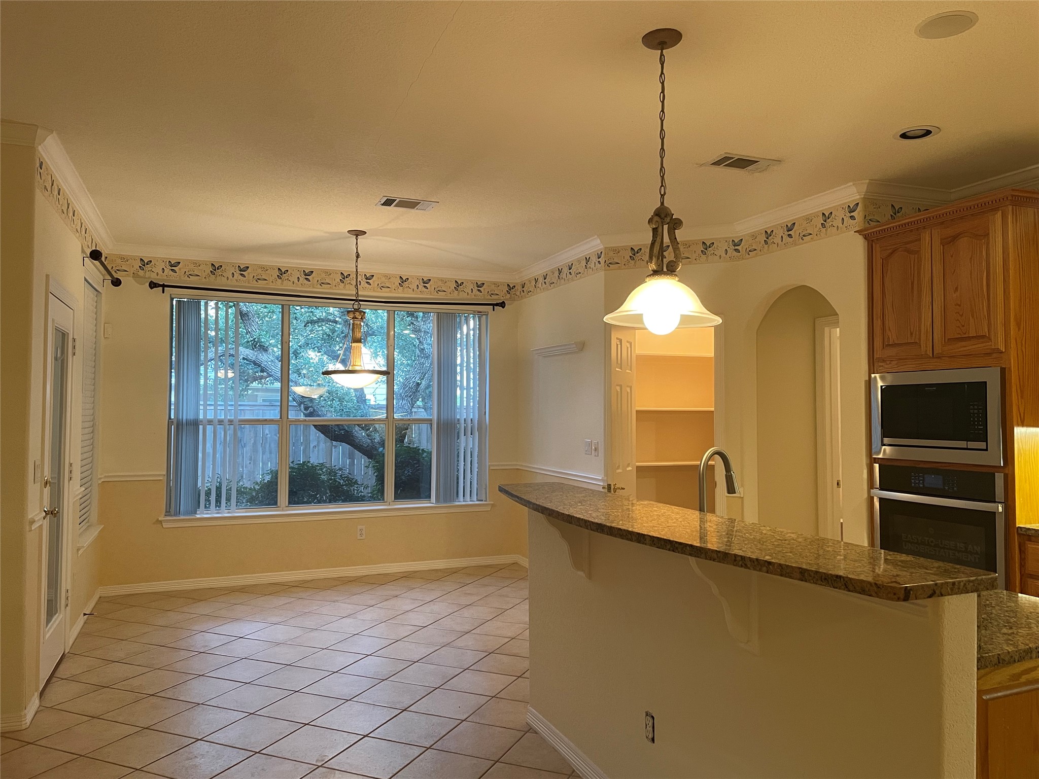 120 Brazos Drive Georgetown, TX 78628 - Photo 12 of 33 a view of a kitchen with a sink wooden floor and a chandelier