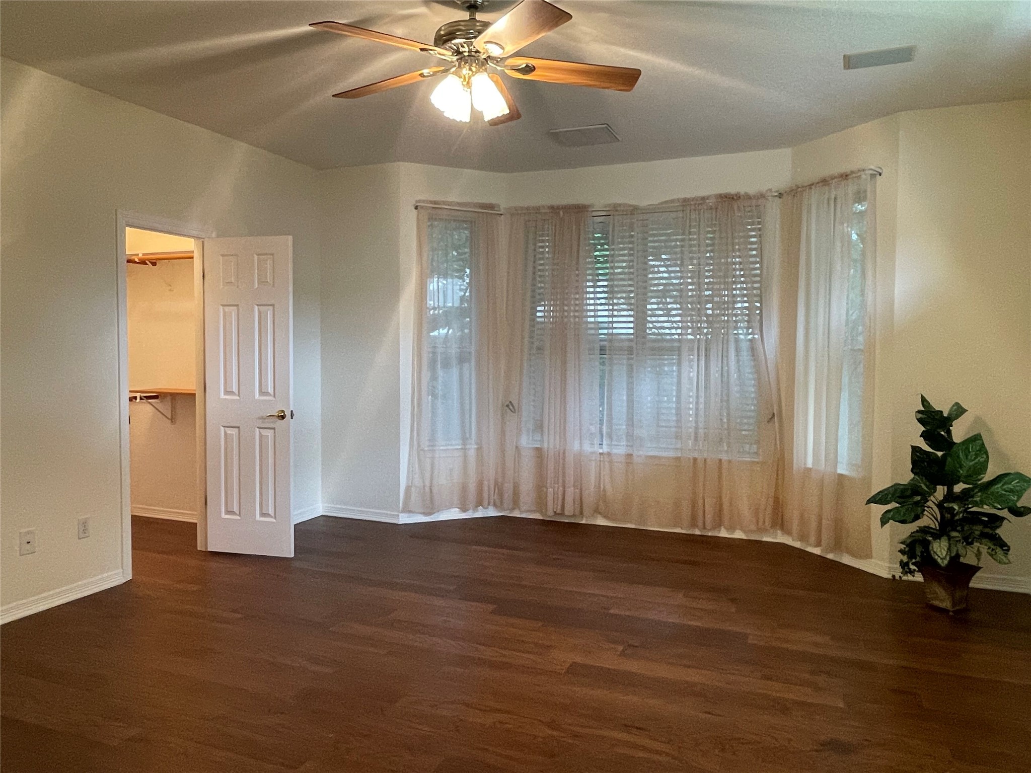 120 Brazos Drive Georgetown, TX 78628 - Photo 21 of 33 an empty room with wooden floor and windows