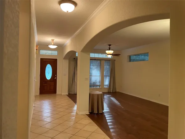 a view of a hallway with wooden floor and windows