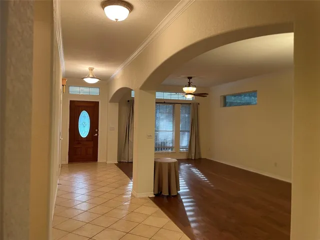 a view of a hallway with wooden floor