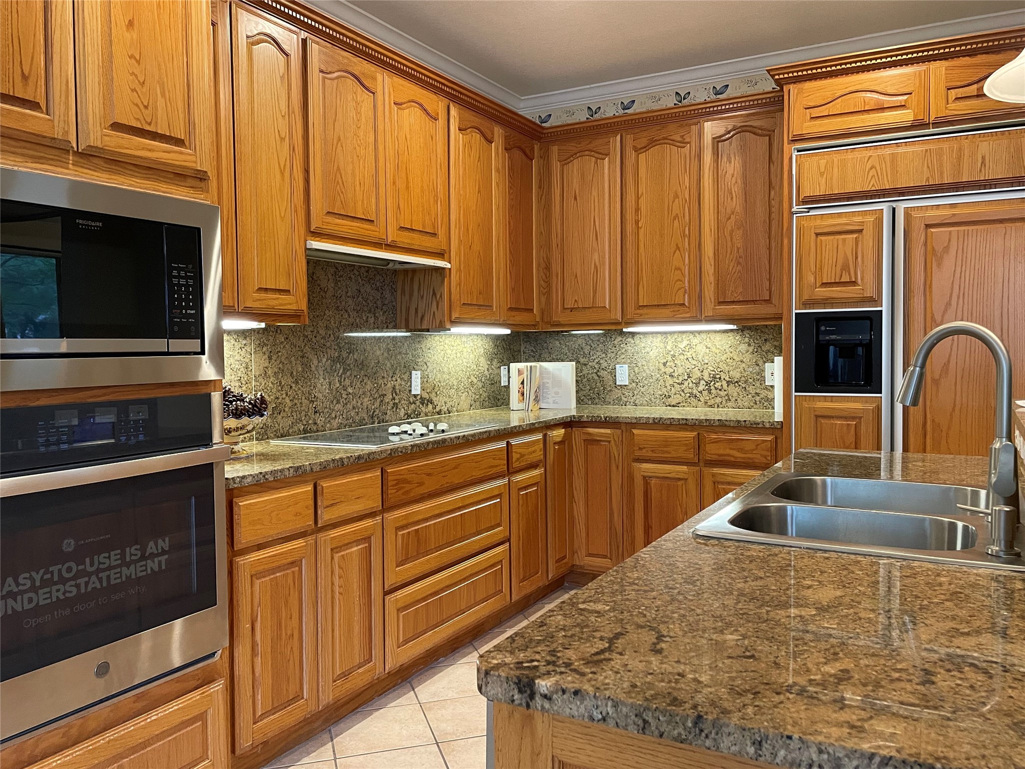 120 Brazos Drive Georgetown, TX 78628 - Photo 9 of 33 a kitchen with granite countertop a sink stove and cabinets