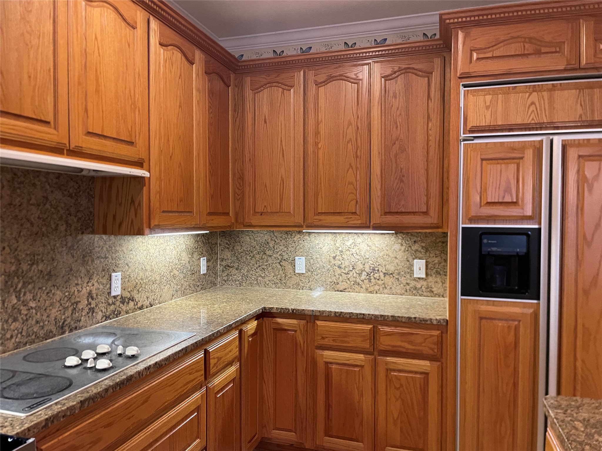 120 Brazos Drive Georgetown, TX 78628 - Photo 10 of 33 a kitchen with granite countertop cabinets and black appliances