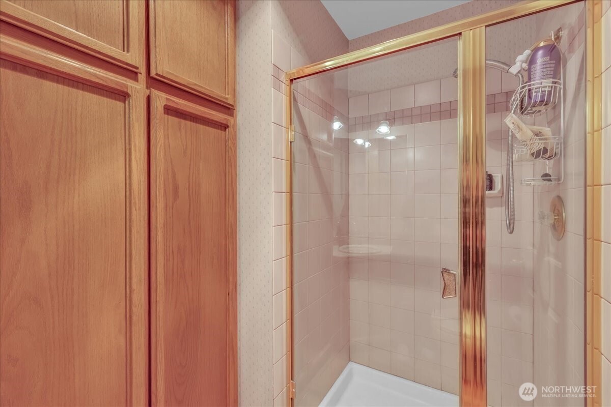 7929 Cyrus Place Edmonds, WA 98026 - Photo 14 of 34 a bathroom with a glass shower door