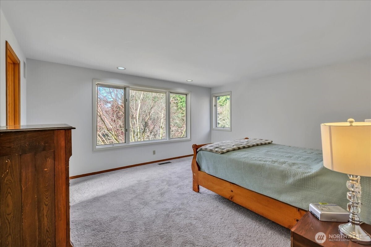 7929 Cyrus Place Edmonds, WA 98026 - Photo 18 of 34 a bed sitting in a spacious bedroom next to a window