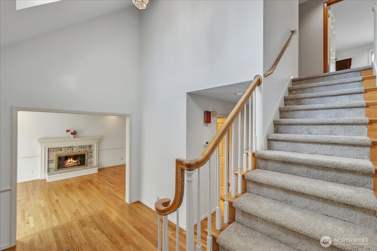 7929 Cyrus Place Edmonds, WA 98026 - Photo 2 of 34 a view of an entryway with wooden floor and a fireplace